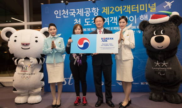 제2여객터미널 첫 고객 맞이 행사에서 우기홍 대한항공 부사장(오른쪽 두 번째)과 첫 손님 정유정씨(오른쪽 세 번째)가 기념촬영을 하는 모습. ⓒ 대한항공