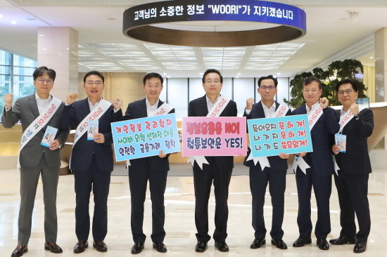 우리금융그룹이 본점에서 정보보호의 날을 맞아 임직원 및 내점 고객 대상 정보보호 캠페인을 실시한다. 사진 왼쪽부터 △황원철 상무 △고정현 상무 △정채봉 부문장 △손태승 회장 △김정기 부문장 △조수형 부행장 △김성종 상무. Ⓒ 우리은행