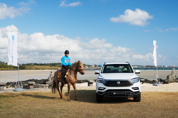 지난 23일 경기가 열린 제주 표선해수욕장에서 출전 기수가 2020 G4 렉스턴 옆에서 포즈를 취하고 있다. ⓒ 쌍용자동차