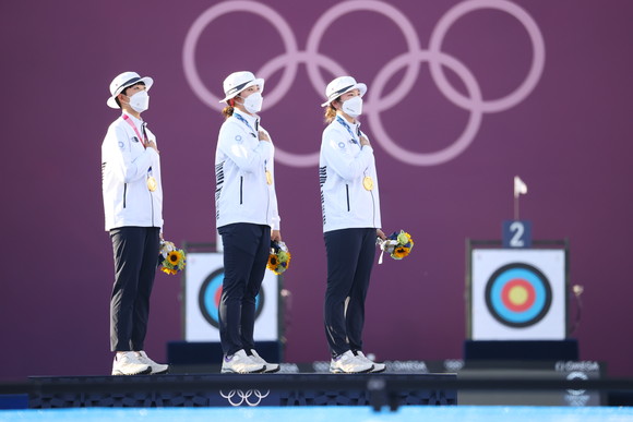 일본 도쿄 유메노시마 공원 양궁장에서 열린 양궁 여자단체전 시상식에서 강채영, 장민희, 안산 선수가 태극기를 바라보며 국기에 경례하고 있는 모습. ⓒ 연합뉴스