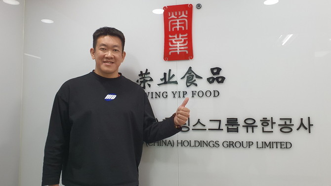 왕현도 윙입푸드 대표이사가 한국 내 서울 사무소 정문에서 포즈를 취하고 있다. = 박기훈 기자