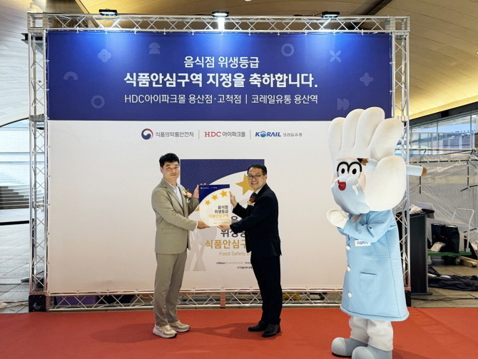 지난 29일 진행된 아이파크몰 '식품안심구역 지정 기념식'에서 최용화 HDC아이파크몰 영업본부장(왼쪽)과 김성곤 식품안전정책국장이 현판 전달 기념촬영을 하고 있다. © HDC아이파크몰