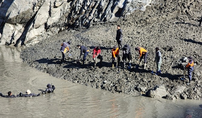 24일 구조대원들이 수중 수색 작업을 벌이는 가운데, 다른 인원들이 하천변에서 진흙을 정리하며 실종자 수색에 나서고 있다. ⓒ 보령소방서