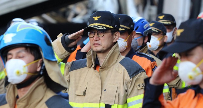 지난 21일 김승룡 소방청장이 대전 대덕구 문평동 공장 화재 현장에서 마지막 실종자를 수습한 뒤 구급차로 이송하기에 앞서 고인에 대한 예우를 표하고 있다. ⓒ 소방청