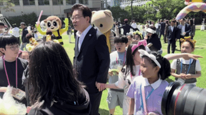 본관에서의 행사를 마치고 이재명 대통령 부부가 녹지원에 방문하자 아이들이 대통령 부부 곁으로 모여들었다. = 김경태 기자