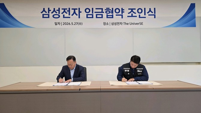 지난달 27일 삼성전자와 삼성전자 노동조합 공동교섭단은 경기 용인시 기흥에 위치한 삼성전자 The UniverSE에서 2026년 임금협약 조인식을 진행했다. 왼쪽부터 여명구 삼성전자 부사장, 최승호 삼성그룹 초기업노동조합 삼성전자 지부 위원장. ⓒ 삼성전자