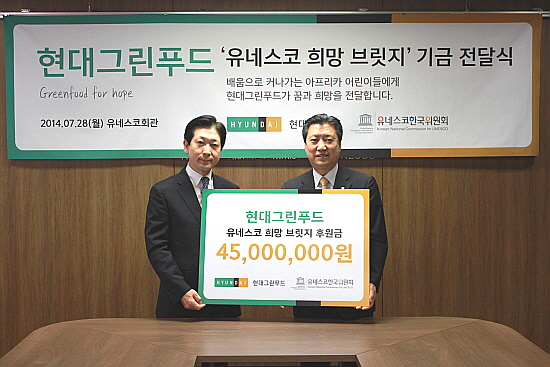  28일, 오흥용 현대그린푸드 사장(사진 왼쪽)이 민동석 유네스코한국위원회 사무총장(사진 오른쪽)에게 아프리카 급식 지원을 위한 기부금을 전달하고 있다. ⓒ 현대그린푸드